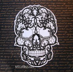 a paper cutout of a skull with intricate designs on it's face and head