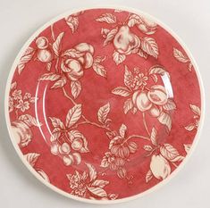 a red and white plate with flowers on it