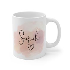 a white coffee mug with the word sarah on it and hearts in black ink