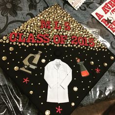 a decorated graduation cap on top of a bed with other decorations and items around it