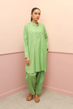 A Co Ord Set- Short length tunic with cuffed sleeves and round neckline. Paired with matching shalwar. Size: UK 12, -  FABRIC Shirt: Viscose Lower: Viscose LENGTH Sleeve Length: Full Shirt Length: Short CARE INSTRUNCTIONS Do not bleach Hand wash cold Line dry in shade Do not wring dry Iron on medium heat Wash/dry light and dark colours separately Traditional Green Kurta For Work, Traditional Kurta For Workwear, Green Pant Set With Straight Kurta For Navratri, Traditional Green Sets For Work, Bollywood Style Palazzo Set With Naqshi, Green Naqshi Palazzo Set With Straight Kurta, Traditional Dabka Kurta For Work, Green Tunic Kurta For Eid, Traditional Unstitched Long Sleeve Suit For Work