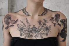 a woman with lots of tattoos on her chest