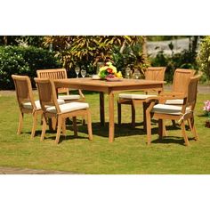 a wooden table and chairs sitting in the grass