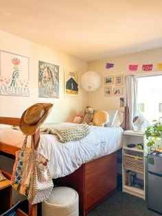 a bed room with a neatly made bed and lots of clutter on the floor