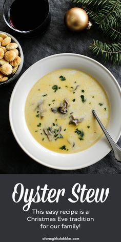 a white bowl filled with soup next to a plate of crackers and christmas decorations