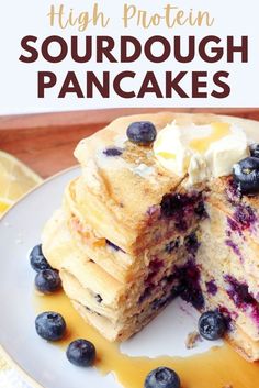 a stack of pancakes with blueberries and butter on top is cut in half to show the inside