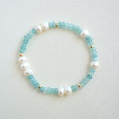 Transform into a seaside goddess with our Aquamarine x Pearls Bracelet! Featuring natural jades and pearls, accented with gold-filled beads, this subtle and stylish piece brings the essence of summer and classic charm to your wardrobe. Embrace the colors of the beach and make a statement with this stunning bracelet. Handmade in the USA Hypoallergenic, water resistant Material: Natural gemstones, 14k gold filled Beaded Bracelets Beach, Alphabet Bracelets, Goddess Bracelet, Pearls Bracelet, Beach Bracelets, Bead Ideas, Jewellery Ideas, Gold Filled Ring, Beaded Cuff