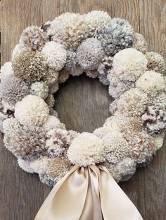 a wreath with white and brown pom - poms on it