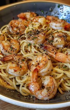 pasta with shrimp and herbs in a bowl