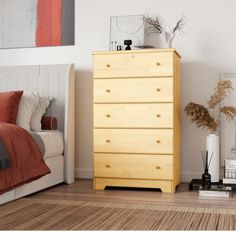 a bedroom scene with focus on the chest of drawers and bed in the foreground