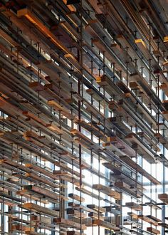 the interior of an office building with lots of bookshelves hanging from the ceiling