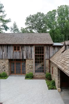 an old brick building with two garages in the front and one on the other side