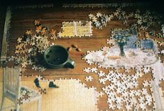 a jigsaw puzzle with a teapot on the floor and other pieces missing