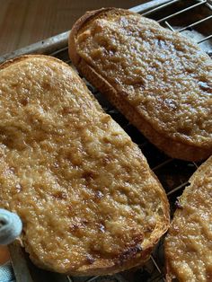 three pieces of bread sitting on top of a cooling rack