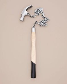 a hammer and chain on a beige background