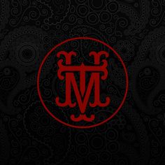 the letter m in a red circle on a black background with swirls and paisley