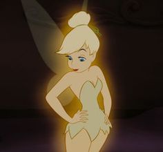 tinkerbell standing in the dark with her hands on her hips