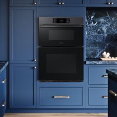 a kitchen with blue cabinets and an oven built into the side of the countertop