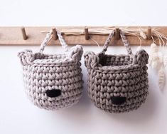 two crocheted baby shoes hanging on a hook