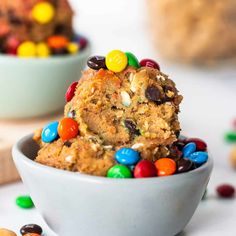 a white bowl filled with cookies and m & m candies