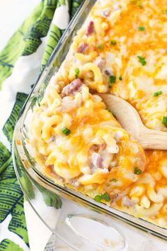 a casserole dish filled with macaroni and cheese on a green napkin