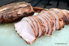 sliced meat sitting on top of a cutting board