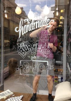 a man standing in front of a store window