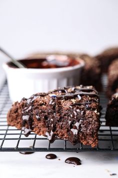 there is a piece of chocolate cake on the cooling rack