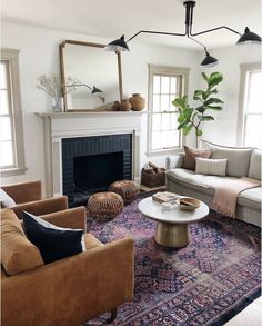 a living room filled with furniture and a fire place in front of a fireplace on top of a rug