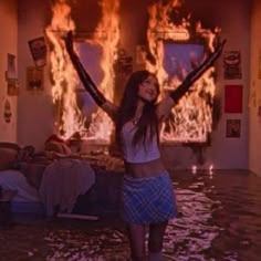 a woman standing in the middle of a flooded room with fire coming from her fireplace