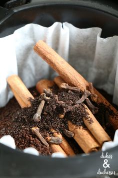 some cinnamon sticks and dirt in a crock pot