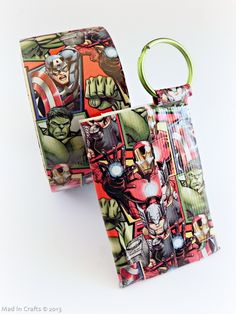 an iron man themed keychain is shown on a white background, with the image of avengers and captain america printed on it