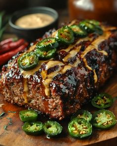 the meatloaf is covered with cheese and jalapenos on the cutting board