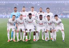 a group of men standing on top of a soccer field