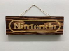 a wooden sign that says nintendo hanging on a wall