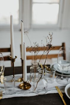 the table is set with candles and dishes