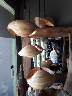 several wooden lamps hanging from the ceiling in a room