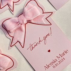 some pink cards with bows on them and the words thank you written in red ink