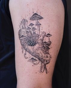 a woman's thigh with mushrooms and other things on her back, in black and white