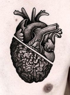 a man's chest with a black and white drawing of a human heart on it