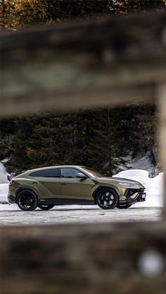 a car parked in the snow behind a fence