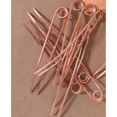 several pairs of copper colored scissors on a table