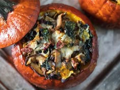 two stuffed pumpkins sitting on top of a table next to each other with different toppings