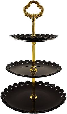 three tiered cake stand with black and gold accents