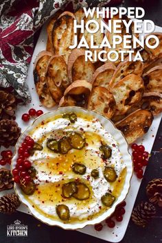 a plate with bread, olives and whipped honeyed jalapeno ricotta