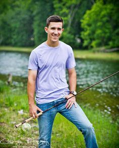 a young man is posing with his fishing rod