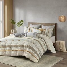 a bedroom with a bed, rugs and pillows on the floor in front of a window