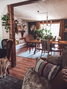 a living room filled with furniture and a wooden table