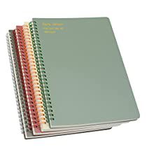 three spiral bound notebooks are stacked on top of each other, with colored pages