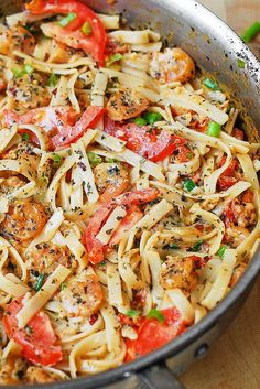 a skillet filled with pasta and vegetables